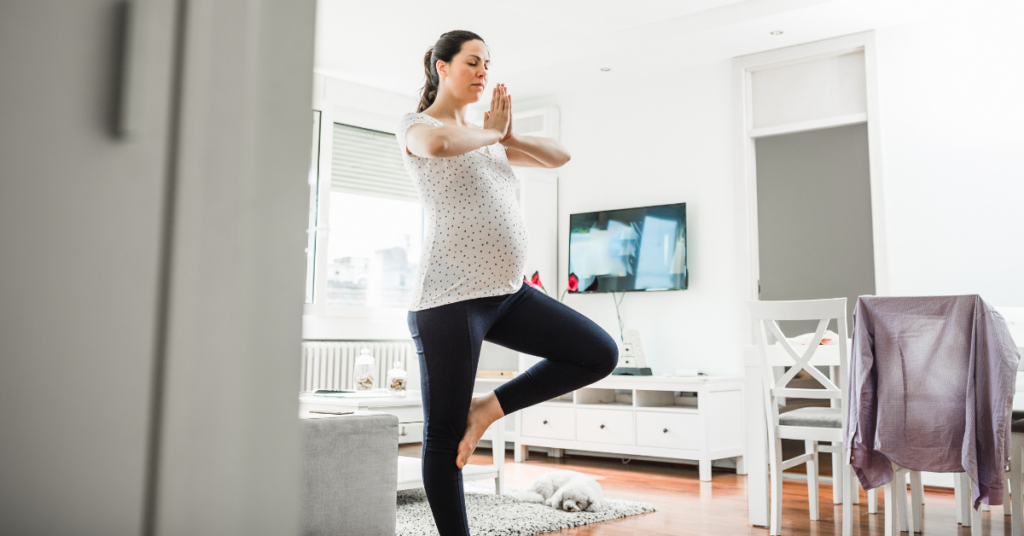 Four months pregnant woman doing yoga