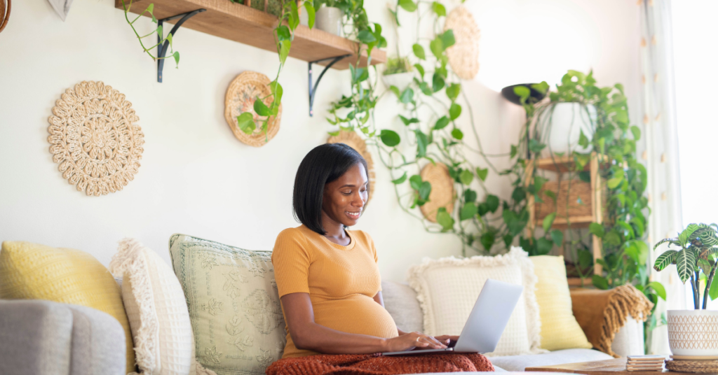 A pregnant mom making her baby registry on her laptop