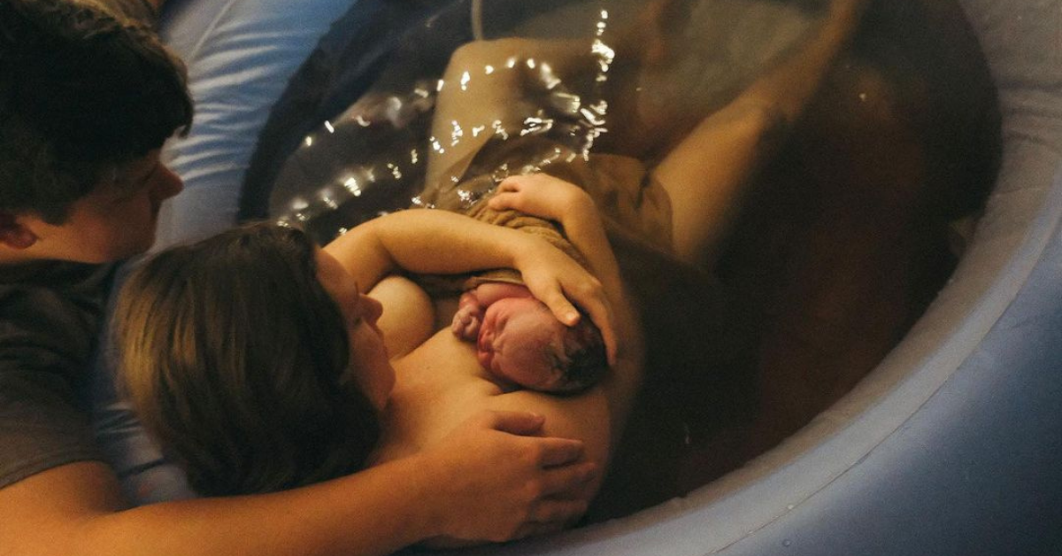 A woman and her husband after having a successful home birth