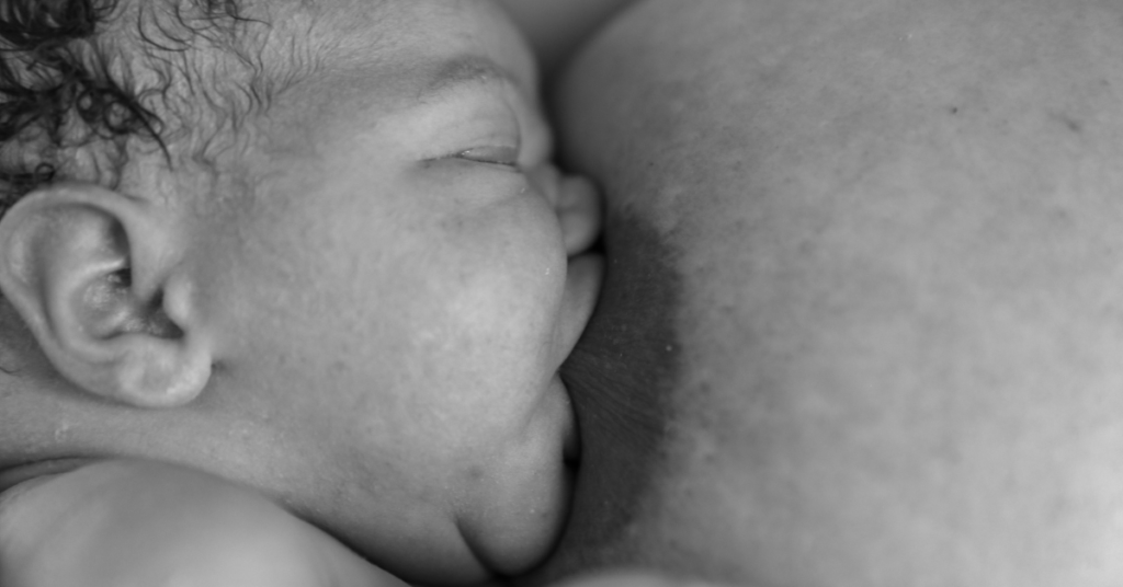 A newly born baby drinking colostrum