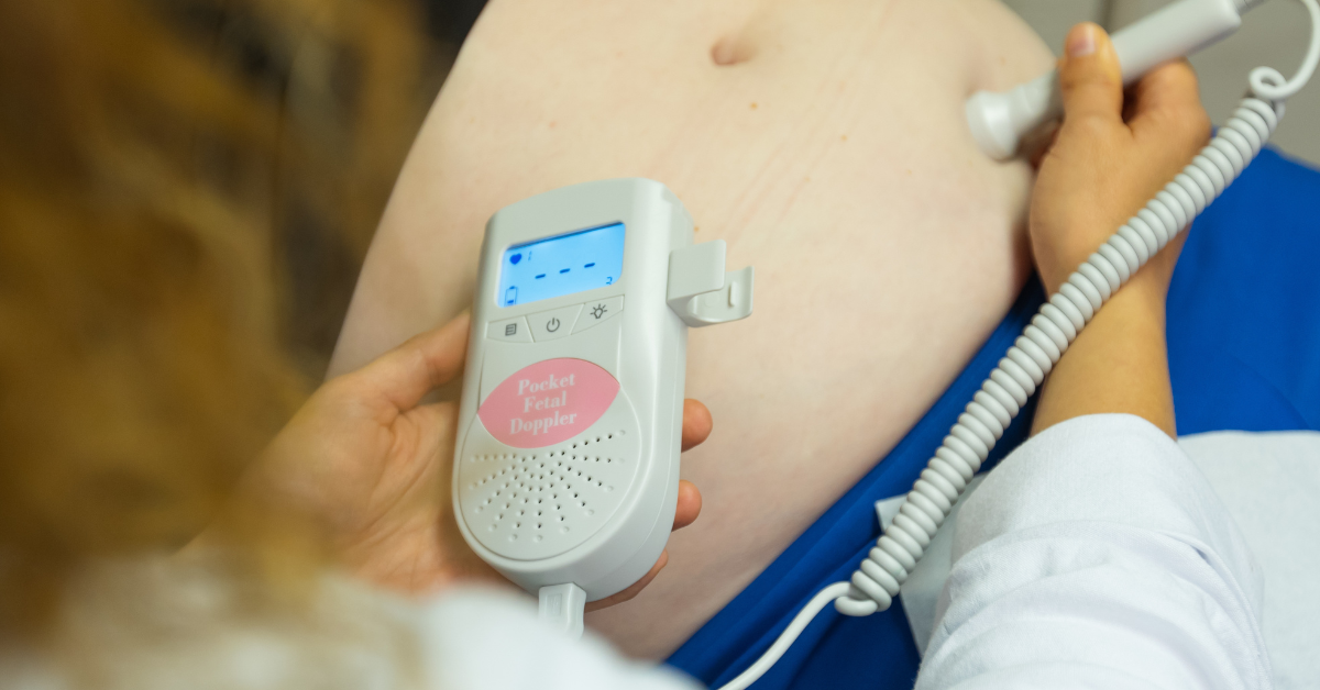 a midwife using a pocket fetal Doppler to help with healthy pregnancy